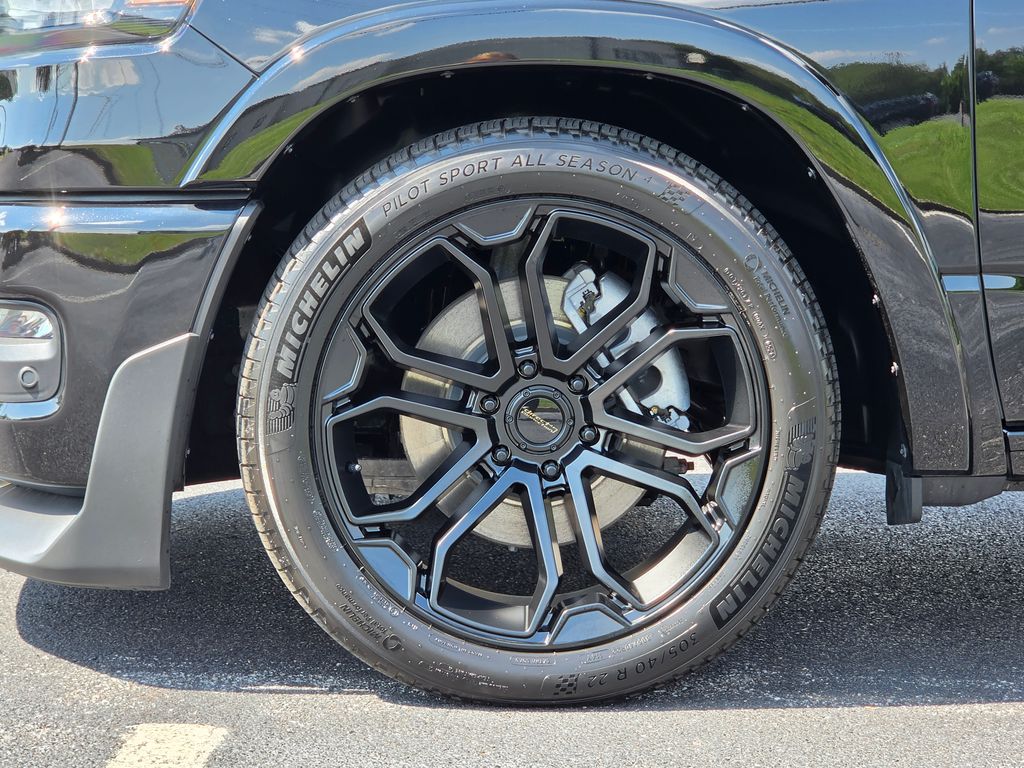 22-inch black alloy wheel with 305/40R22 Michelin Pilot Sport performance tire on Ram DC650