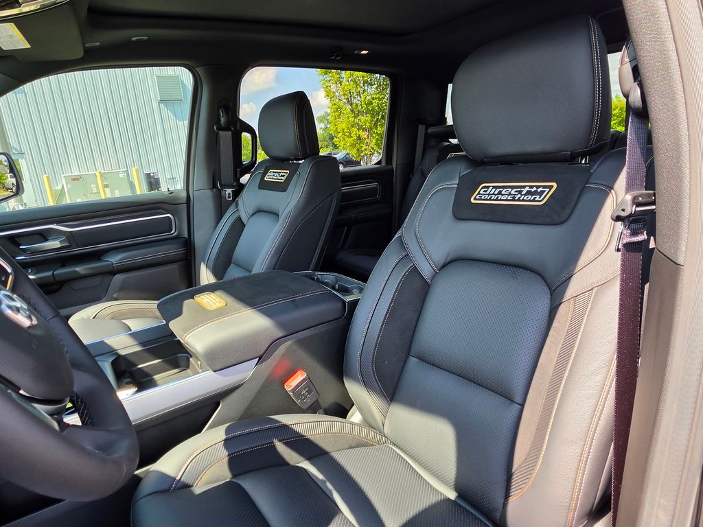 Direct Connection embroidered gold logo on black leather headrest inside 2026 Ram 1500 DC650