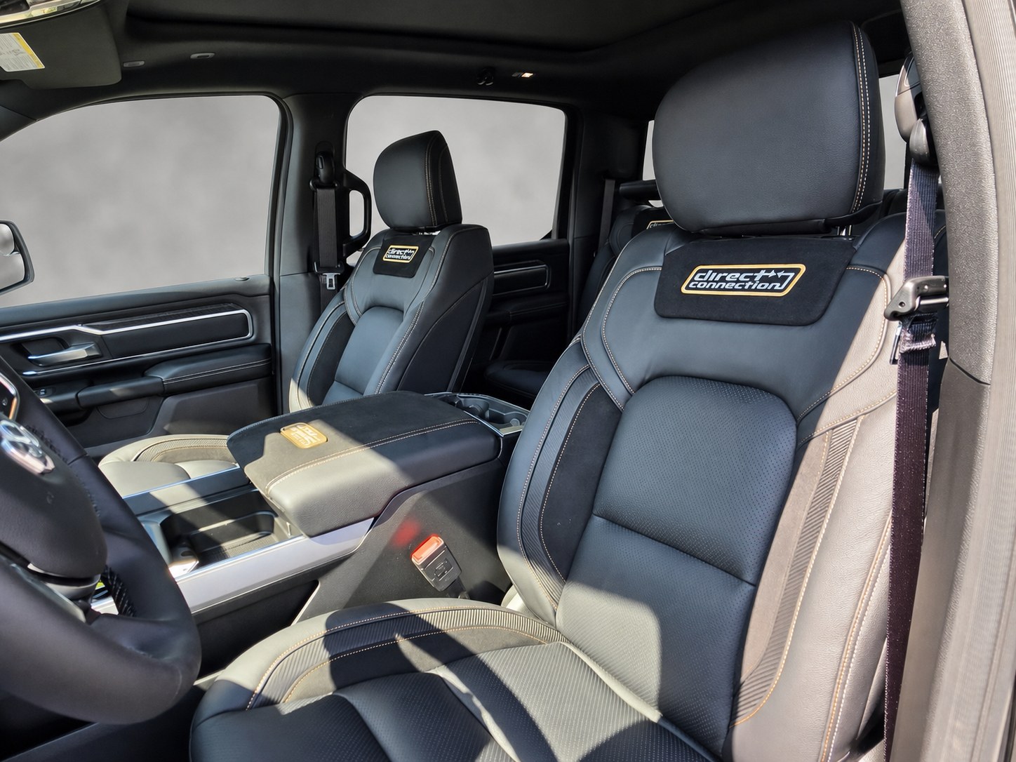 Direct Connection embroidered gold logo on black leather headrest inside 2026 Ram 1500 DC650